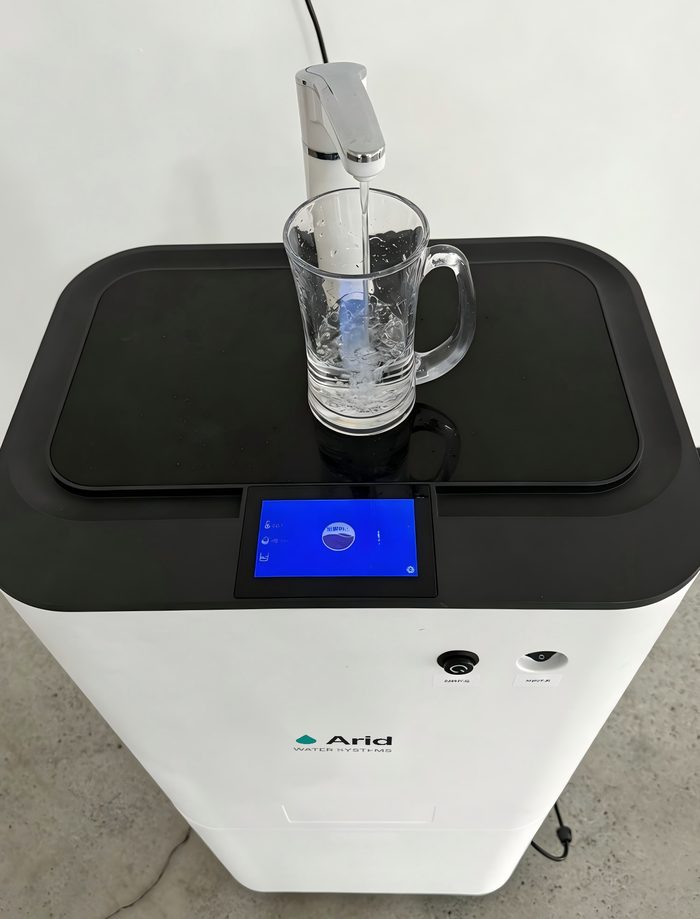 Arid Home demonstration unit filling a glass from the dispensing tap